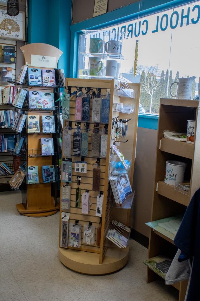 Books stacked on shelves in a bookstore.