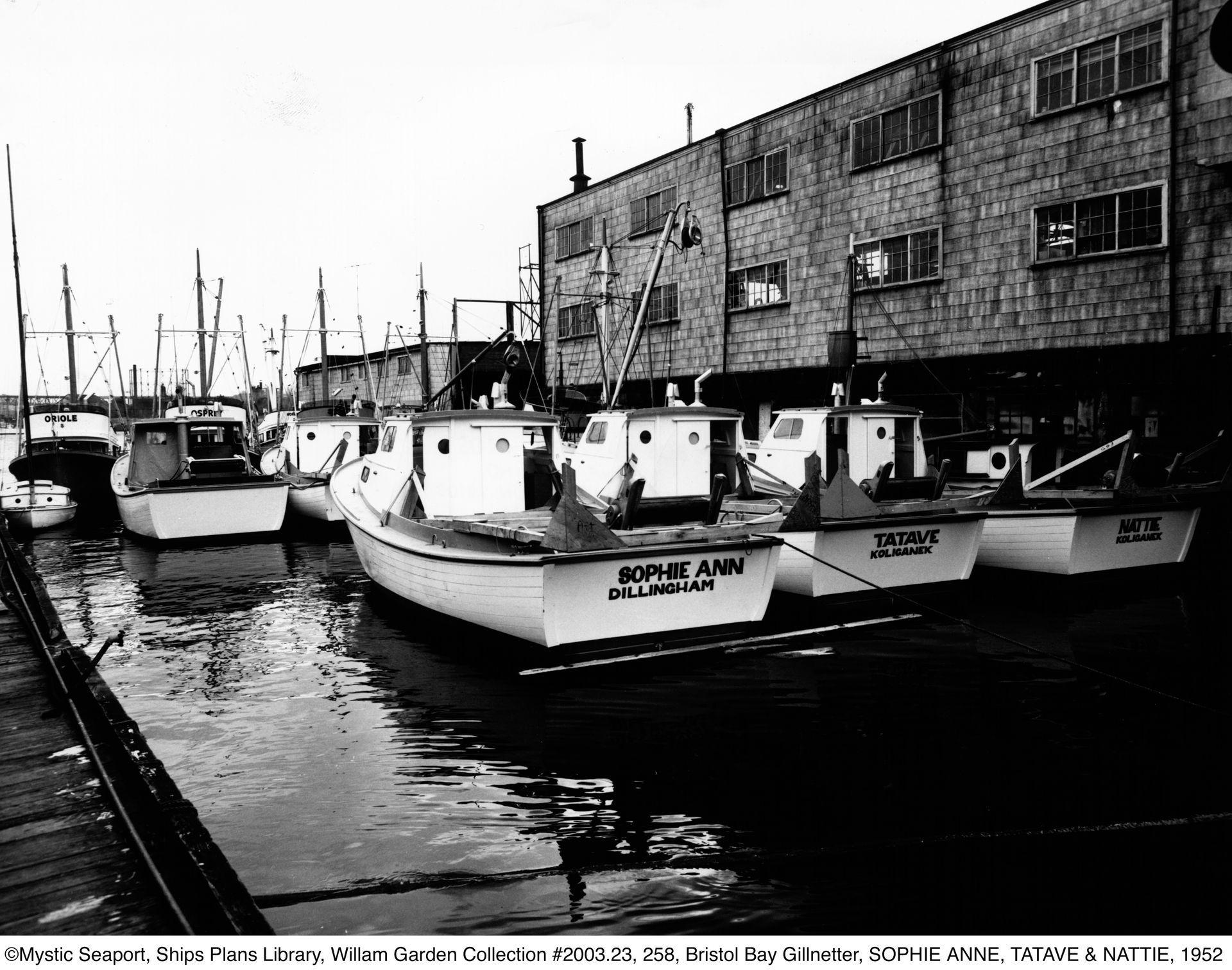 A black and white photo of boats in a harbor