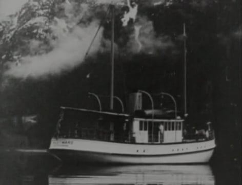 A black and white photo of a boat in the water