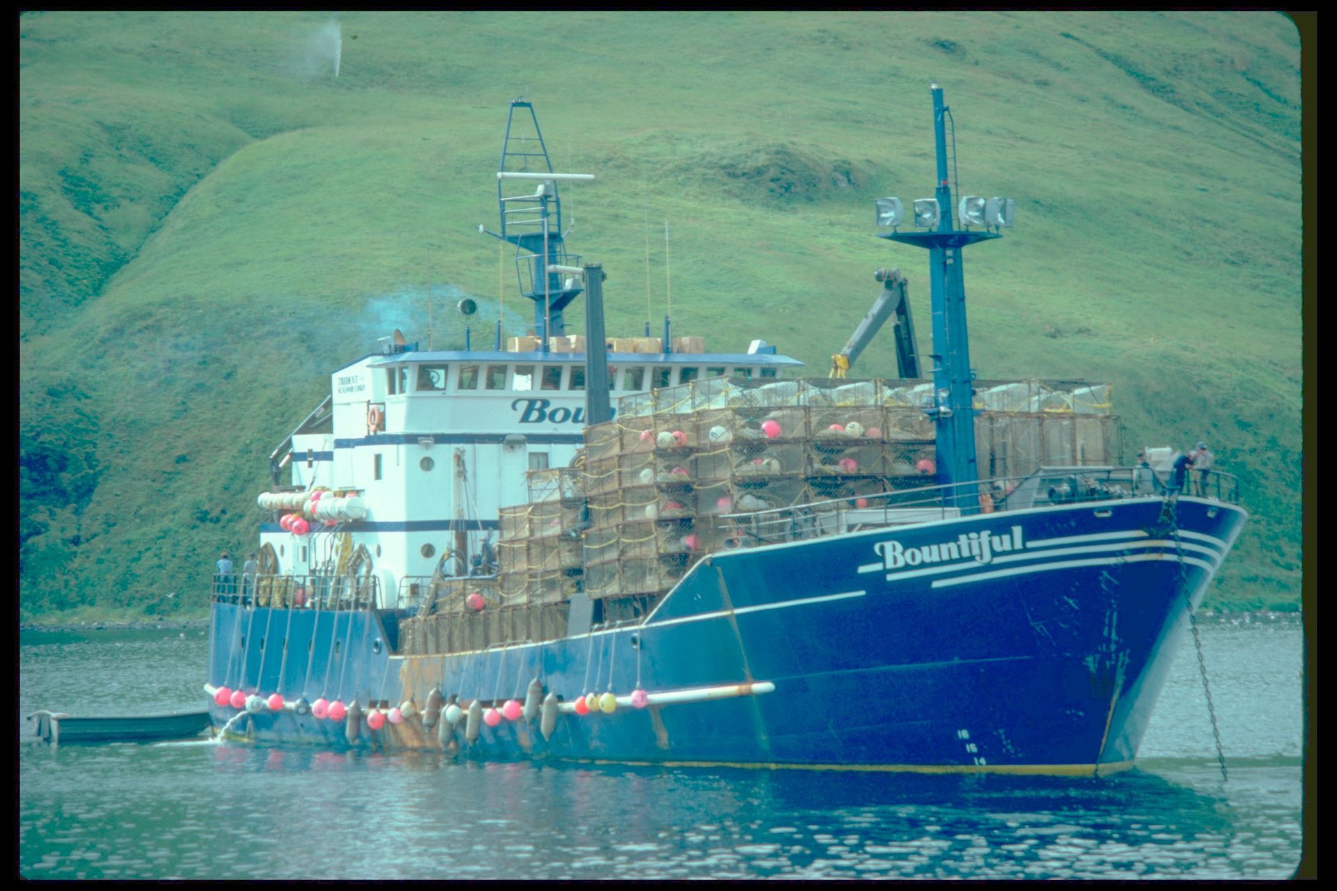 A large blue ship with the name beautiful on the side