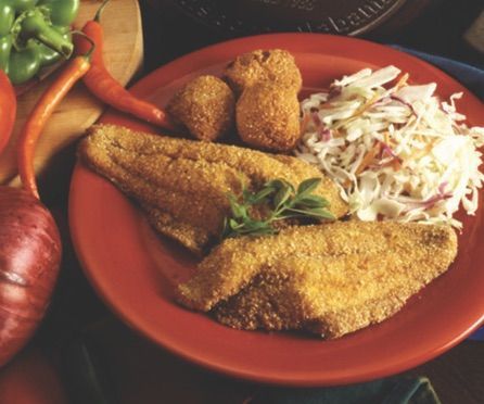 A red plate topped with fried fish and coleslaw