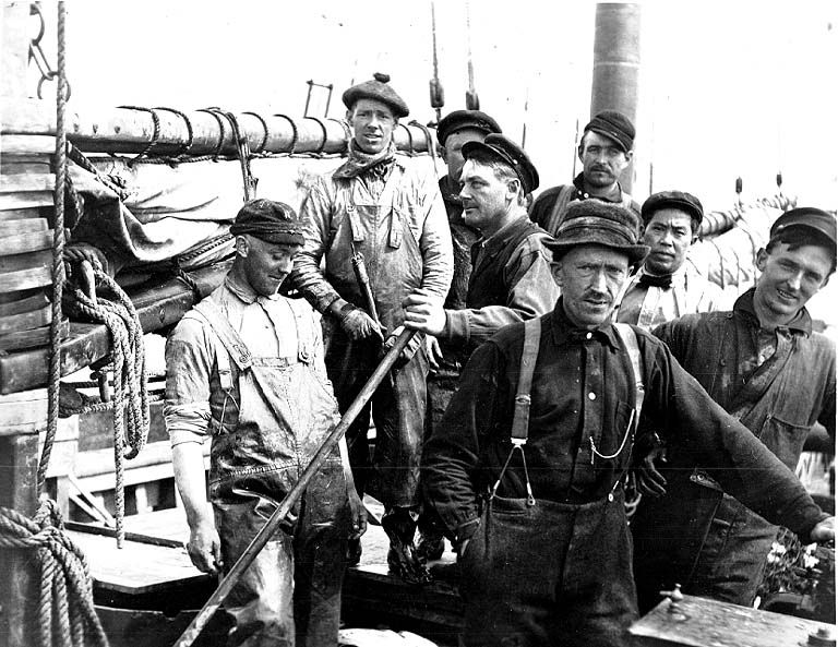 A group of men are posing for a picture on a boat.