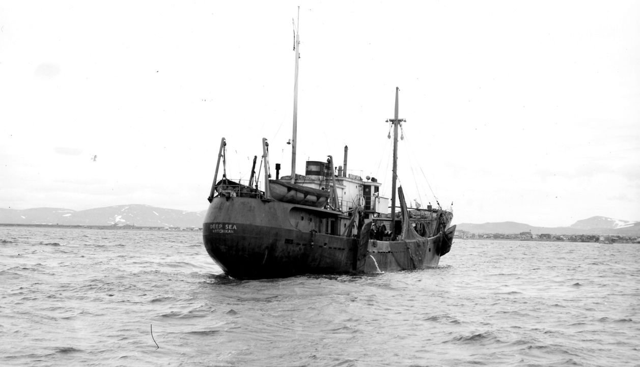 A black and white photo of a boat in the ocean