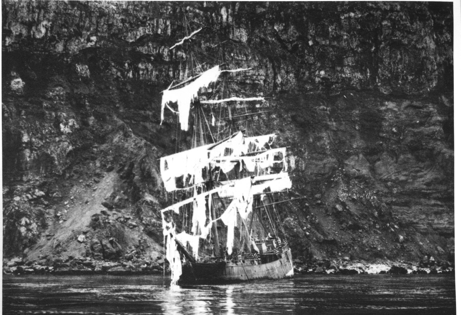 A black and white photo of a sailboat in the water