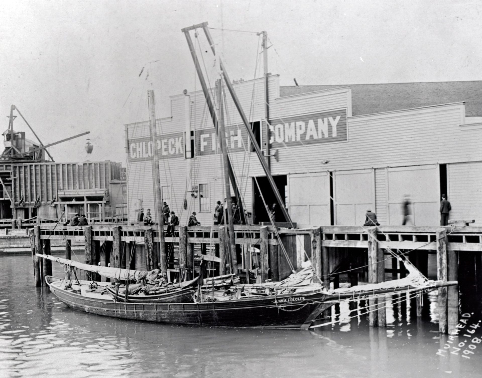 A black and white photo of a fish company building