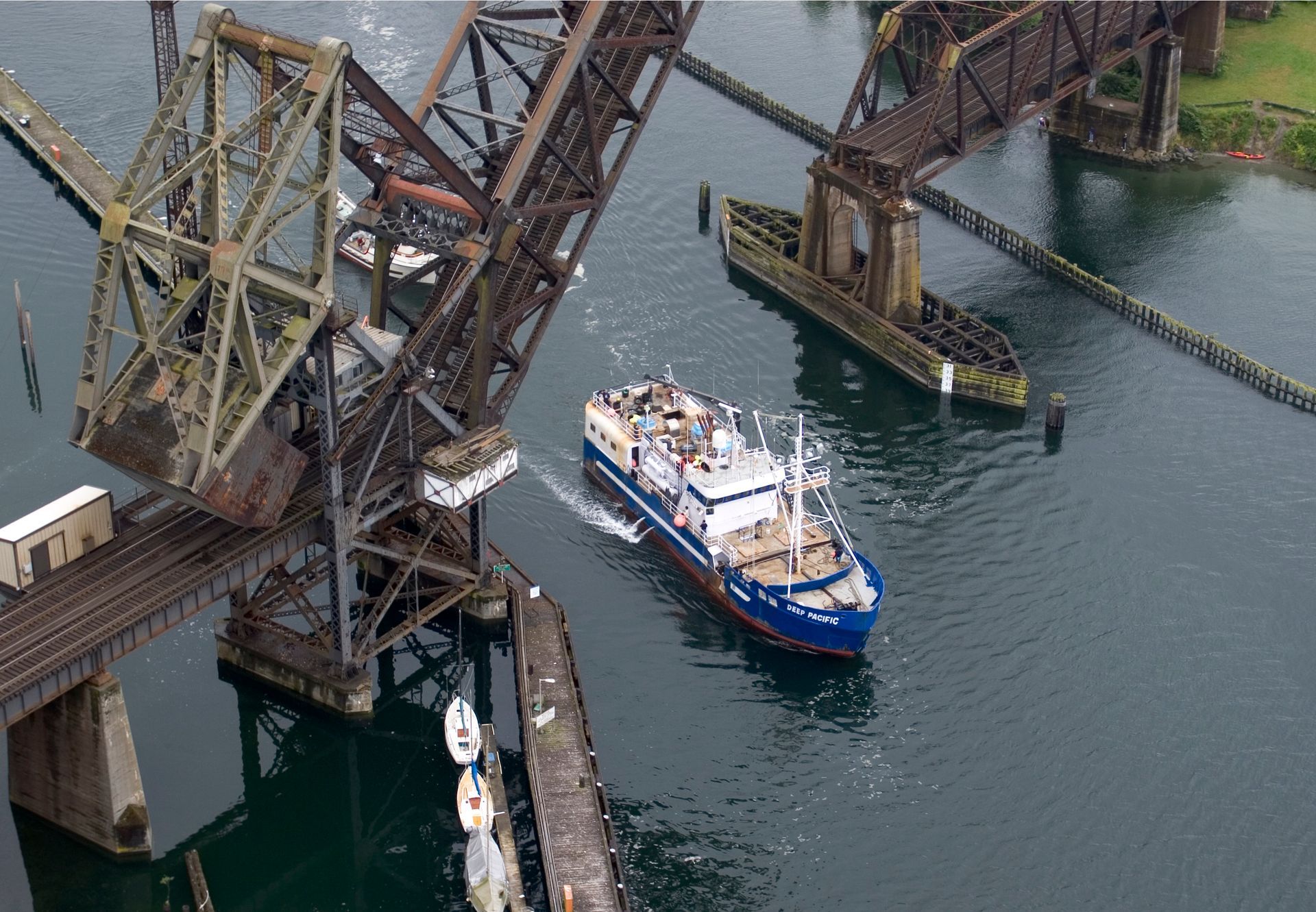 An aerial view of a bridge and a boat in the water