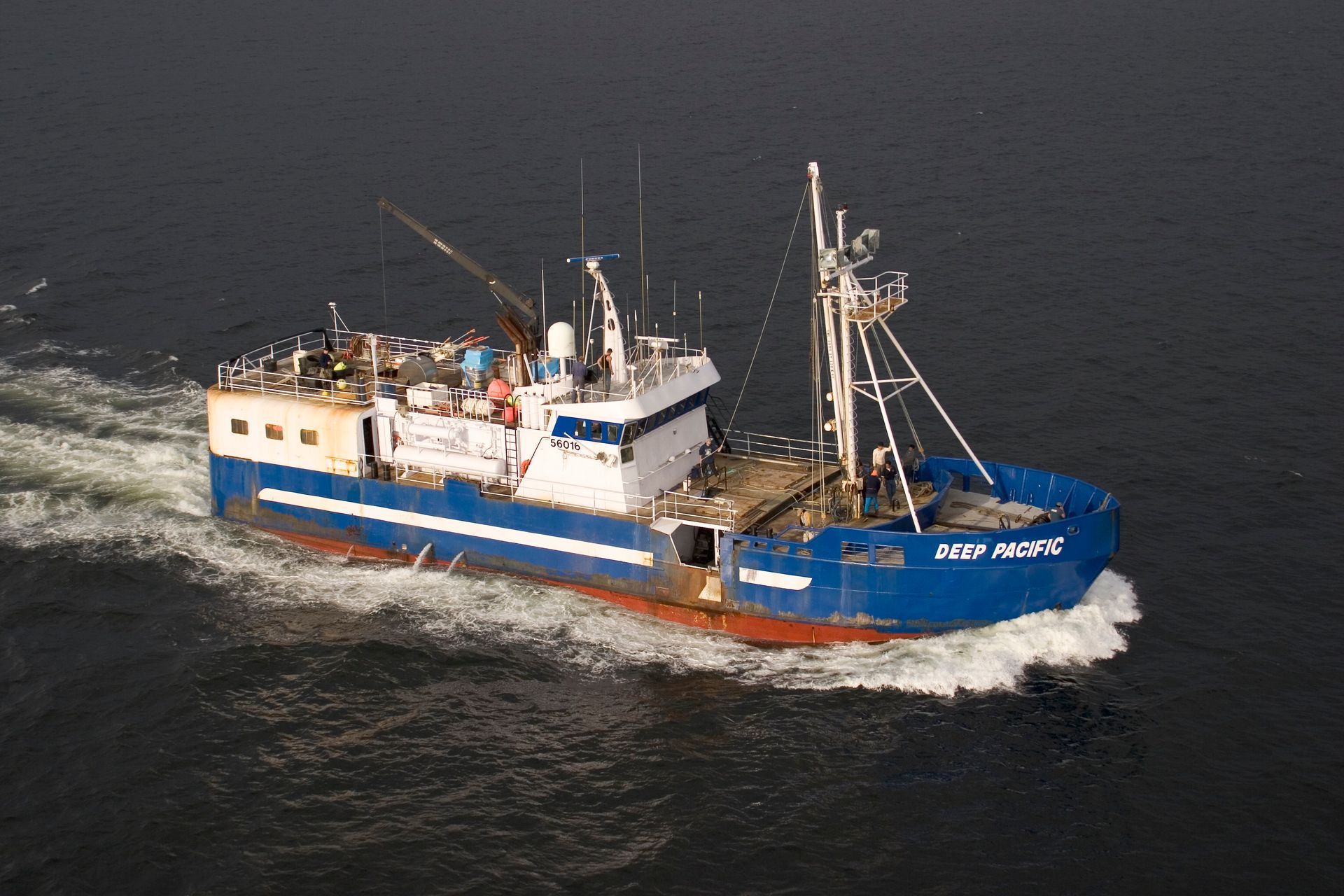 A large blue ship with the name deep pacific on the side