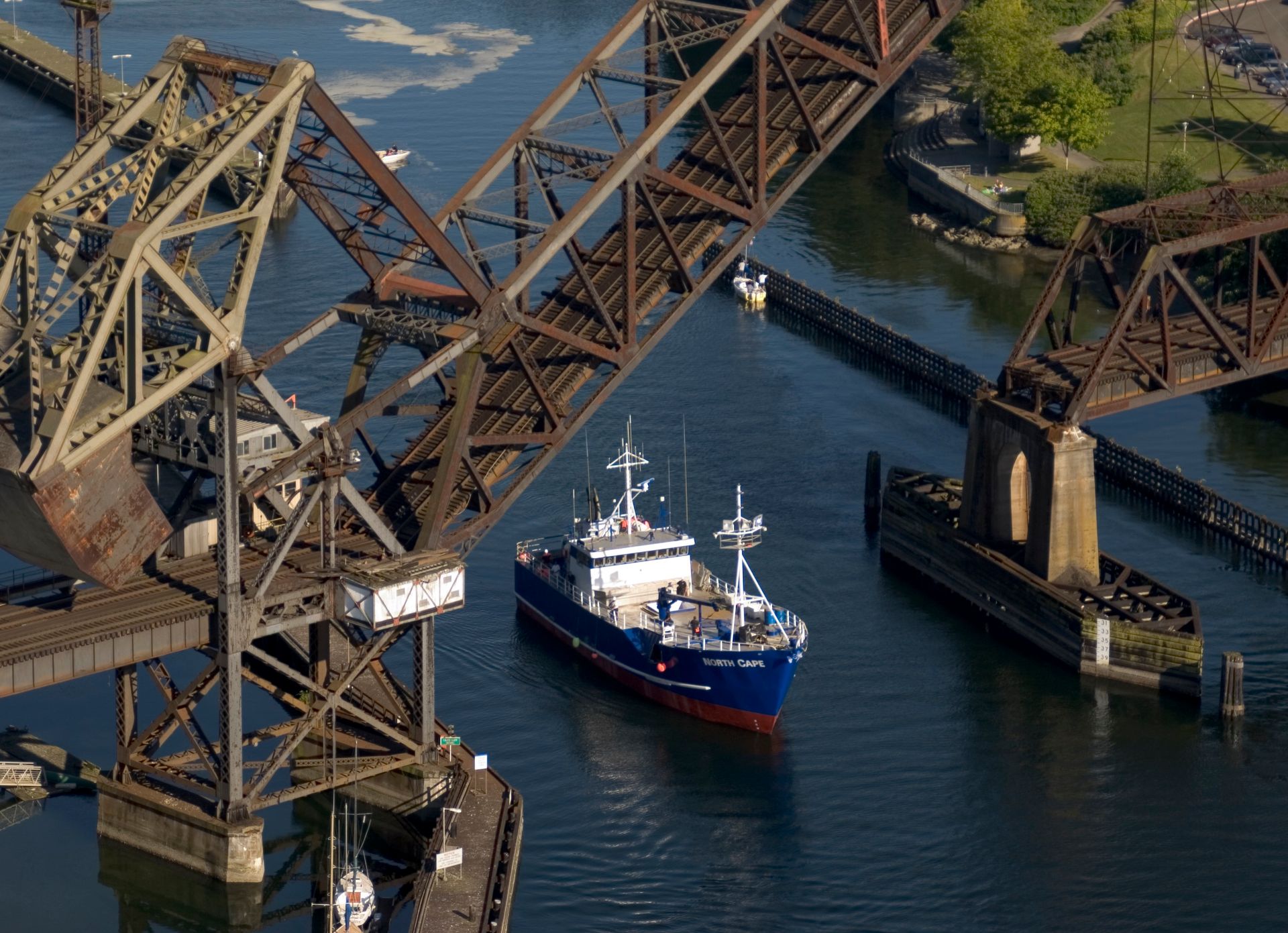 An aerial view of a bridge and a boat in the water