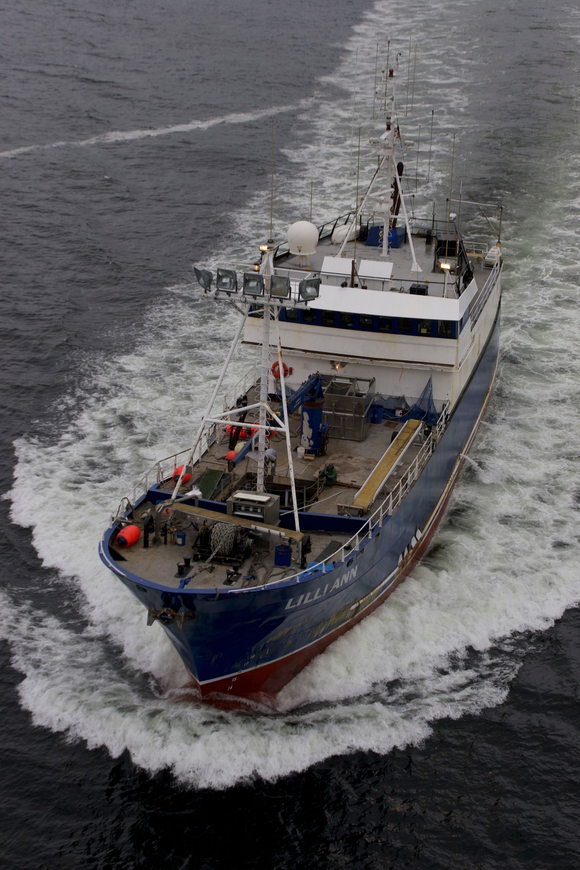A large ship is floating on top of a body of water.