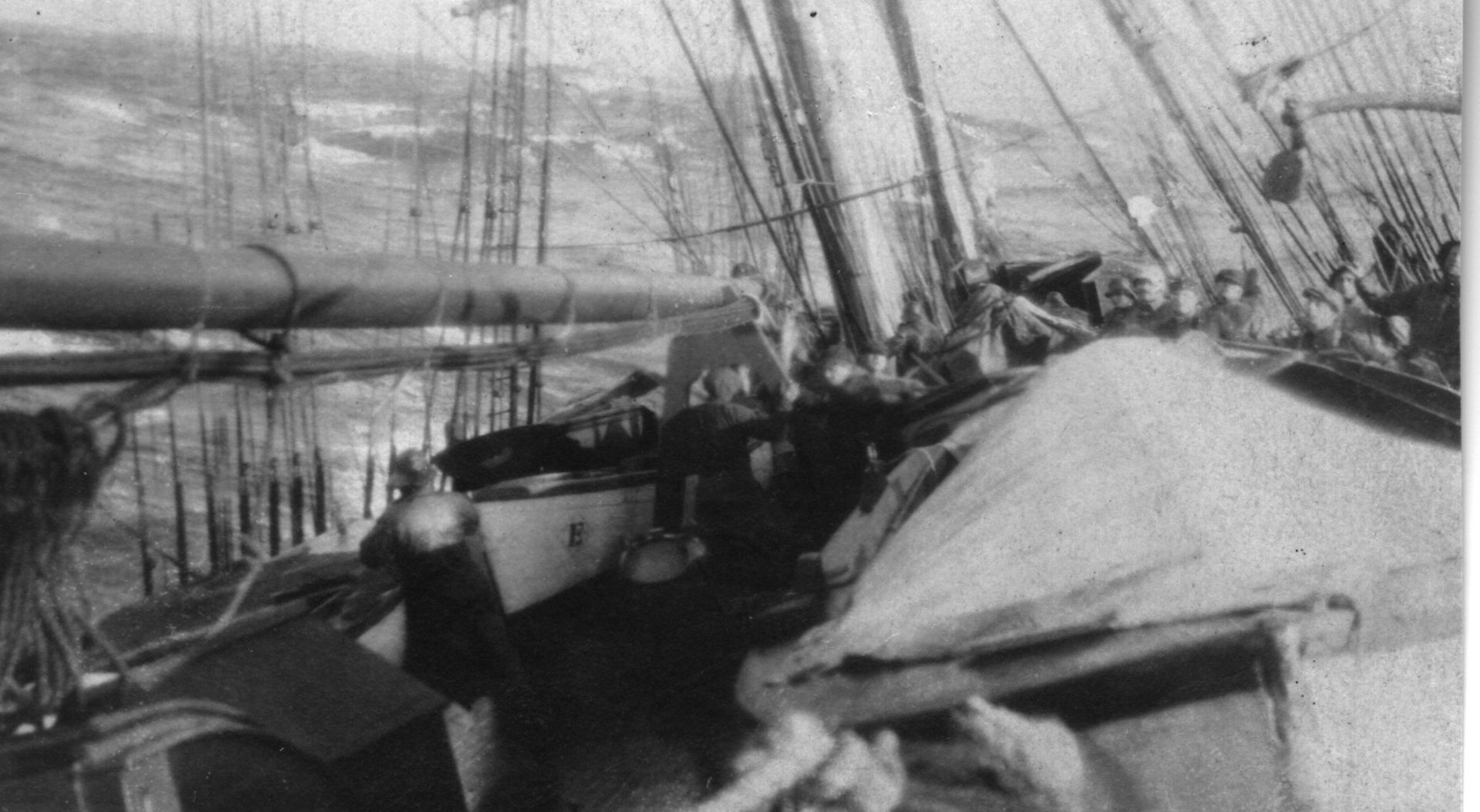 A black and white photo of a boat with people on it.