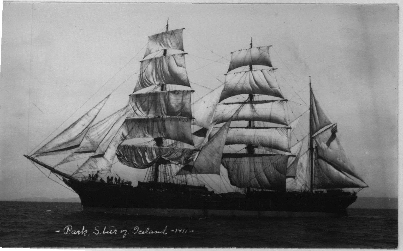A black and white photo of a sailboat in the ocean