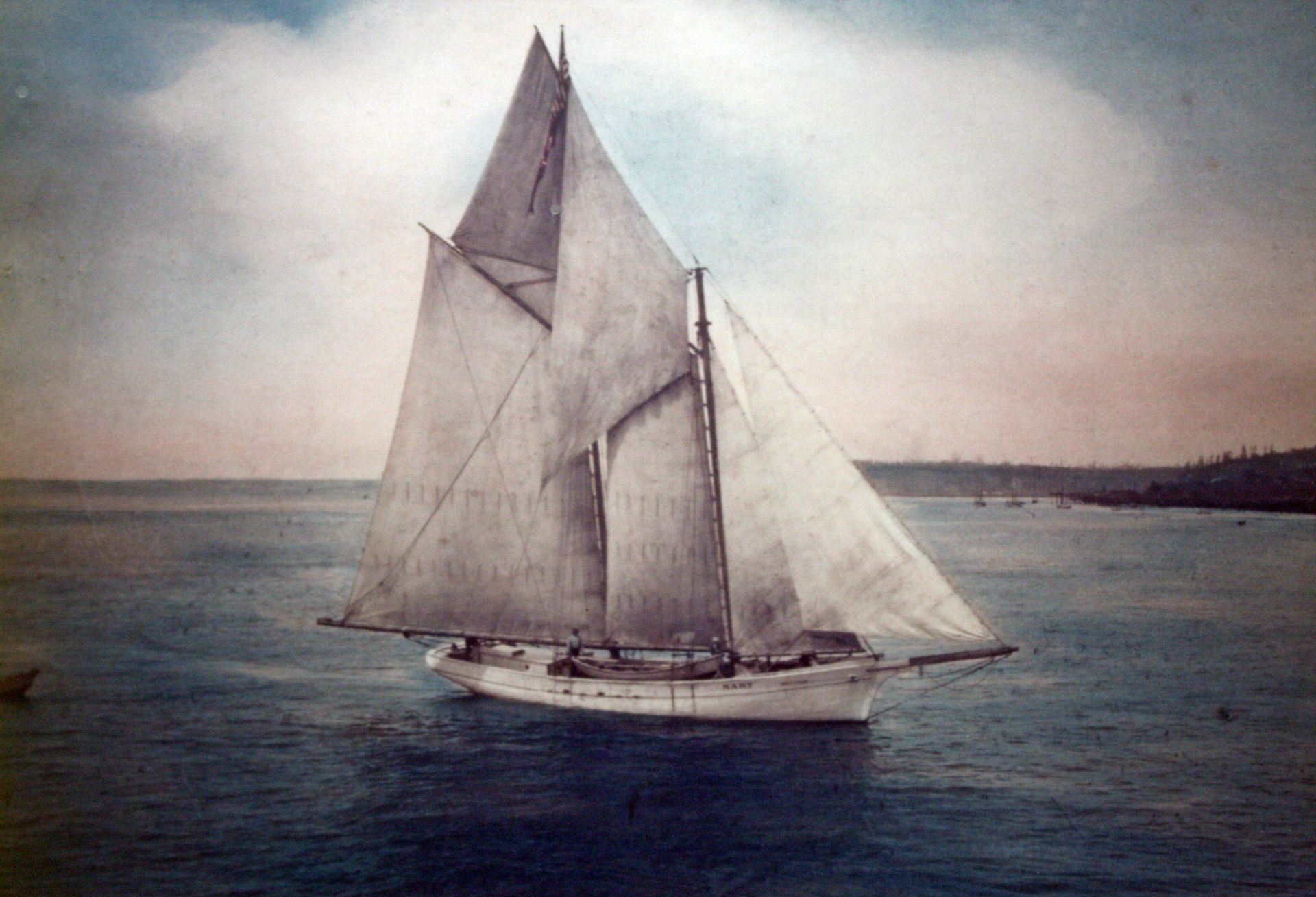 A sailboat is floating on top of a body of water.