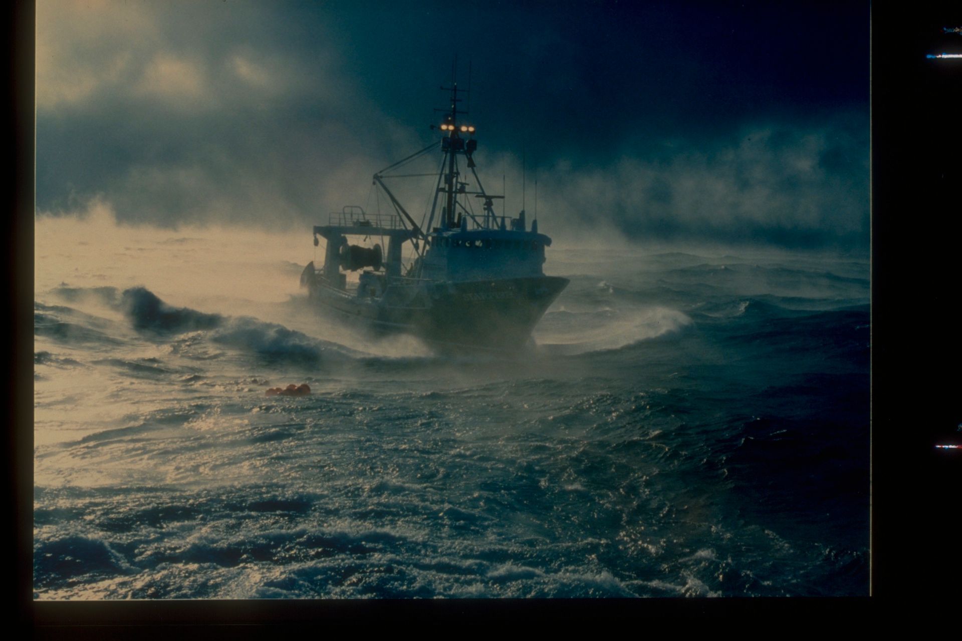 A boat is floating on top of a large body of water.