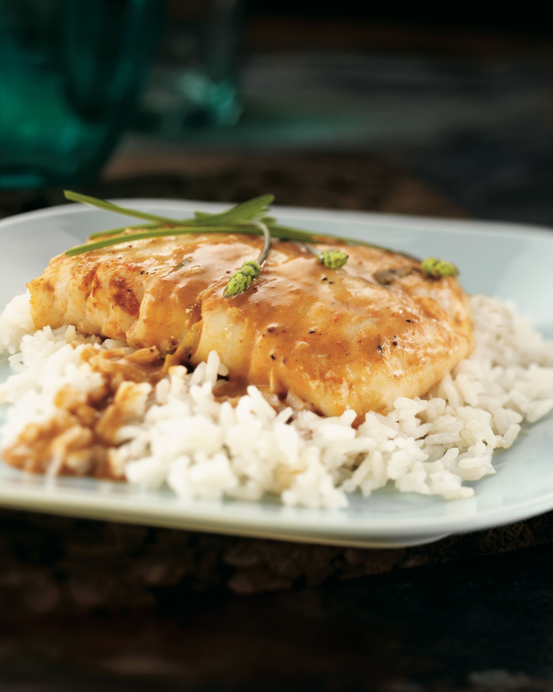 A plate of food with rice and meat on a table.