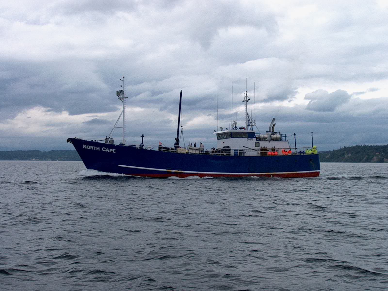 A large boat is floating on top of a body of water