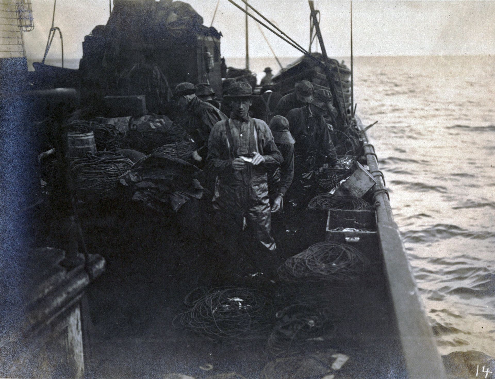 A black and white photo of people on a boat