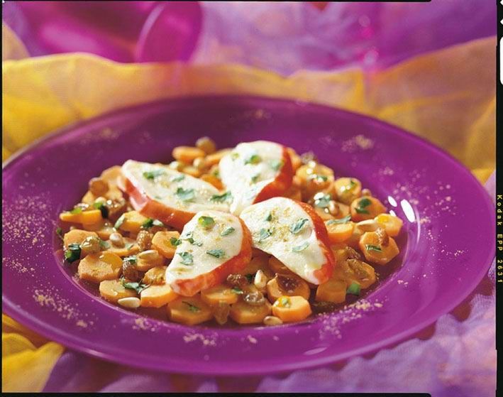 A purple plate topped with vegetables and a slice of cheese