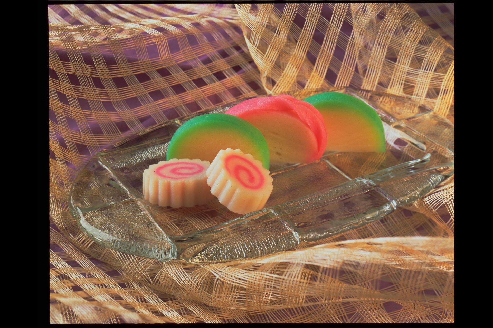 A glass plate with three different colored candy on it