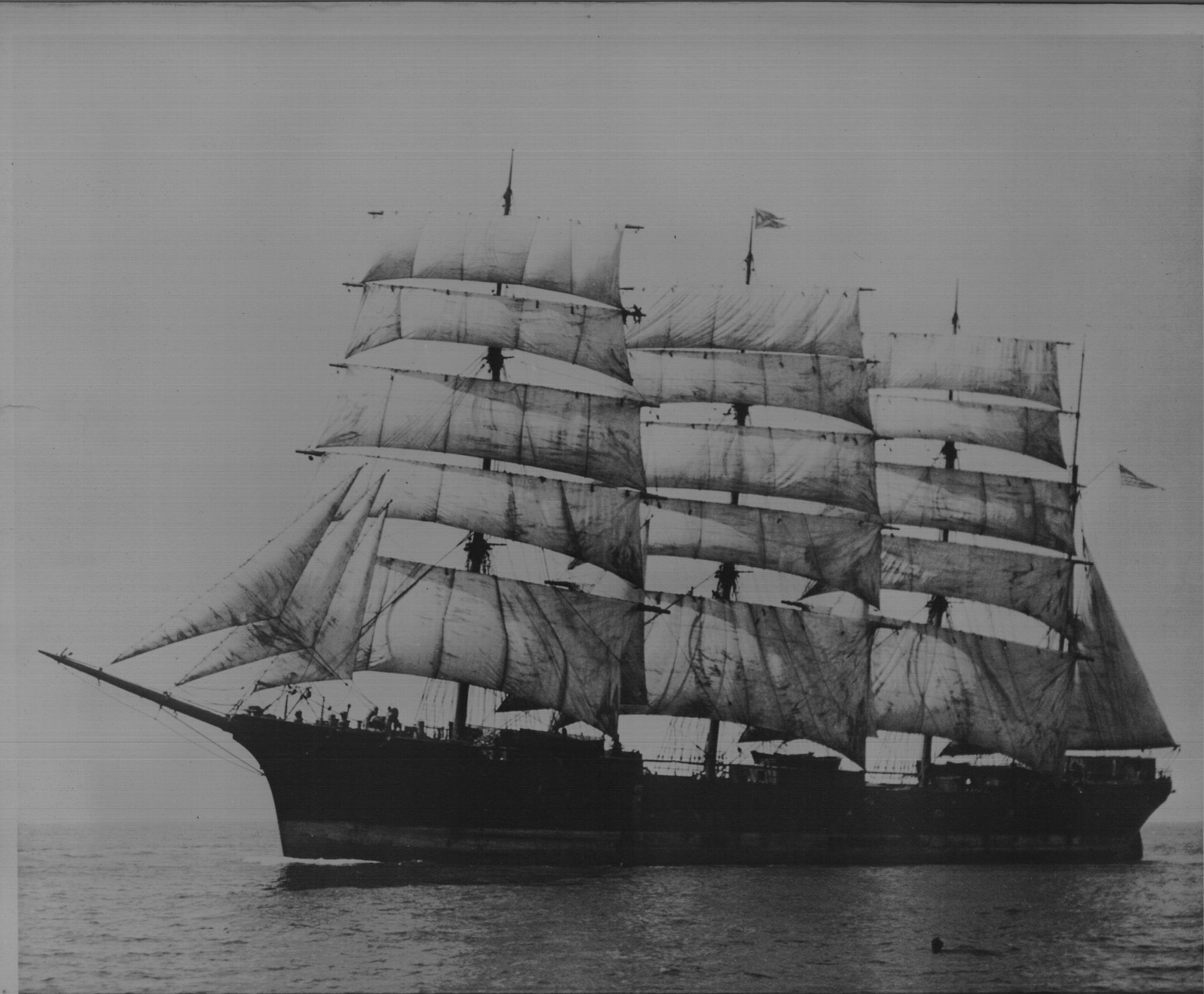 A black and white photo of a sailboat in the ocean