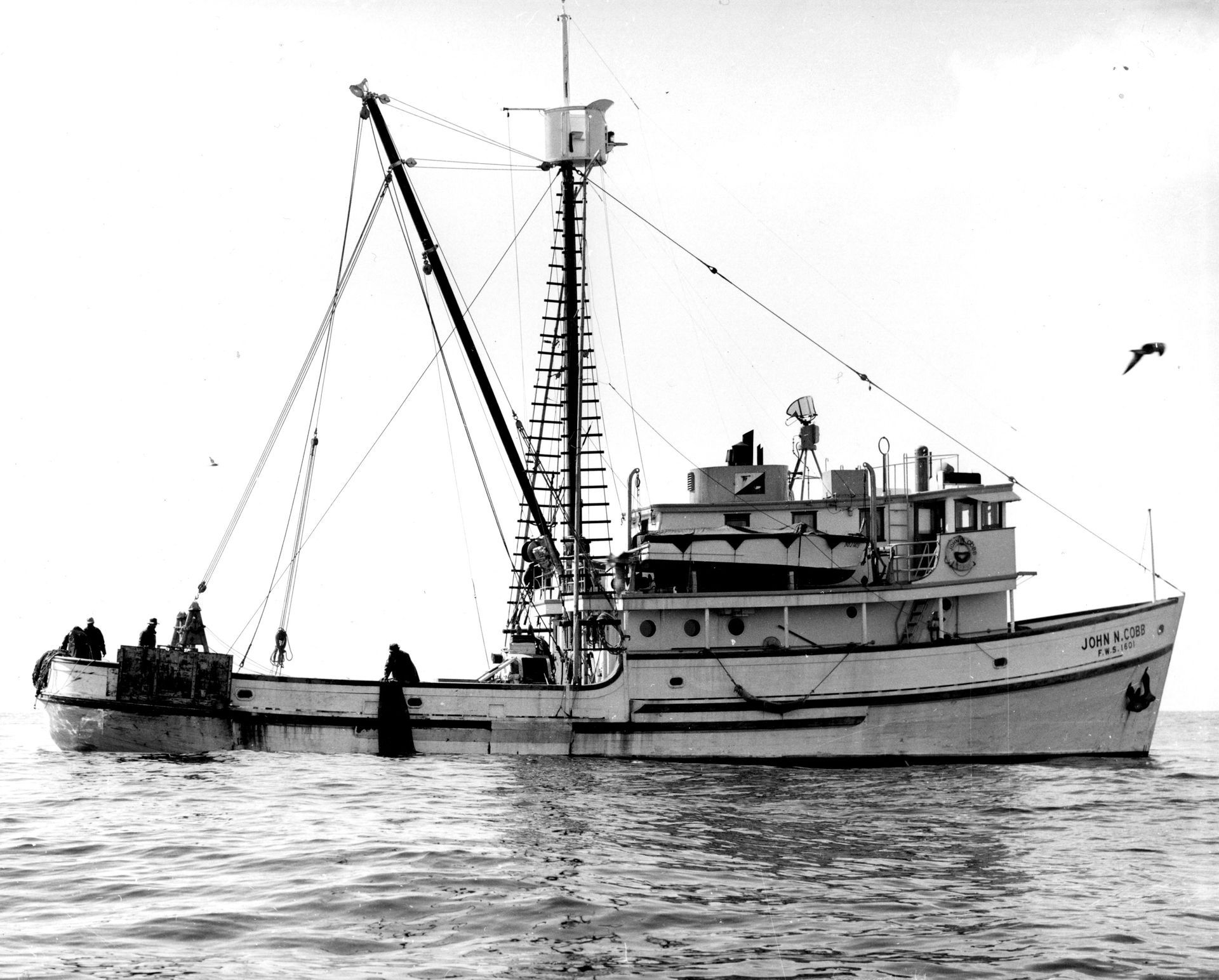 A black and white photo of a large fishing boat with the number 24 on the side