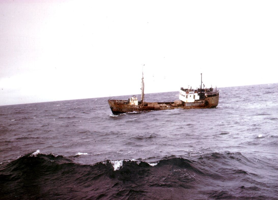 A boat is floating on top of a large body of water