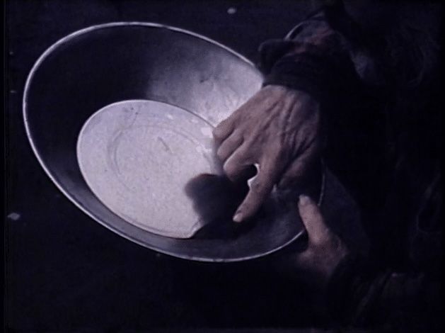 A person is holding a bowl with a plate in it