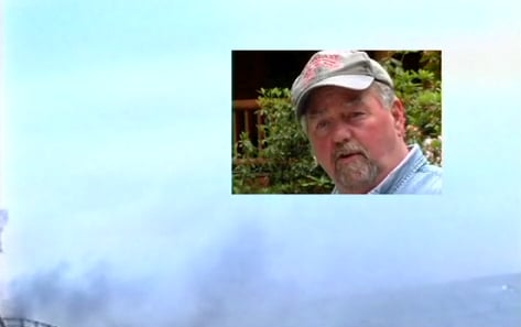 A man with a beard is wearing a hat and looking at the camera.