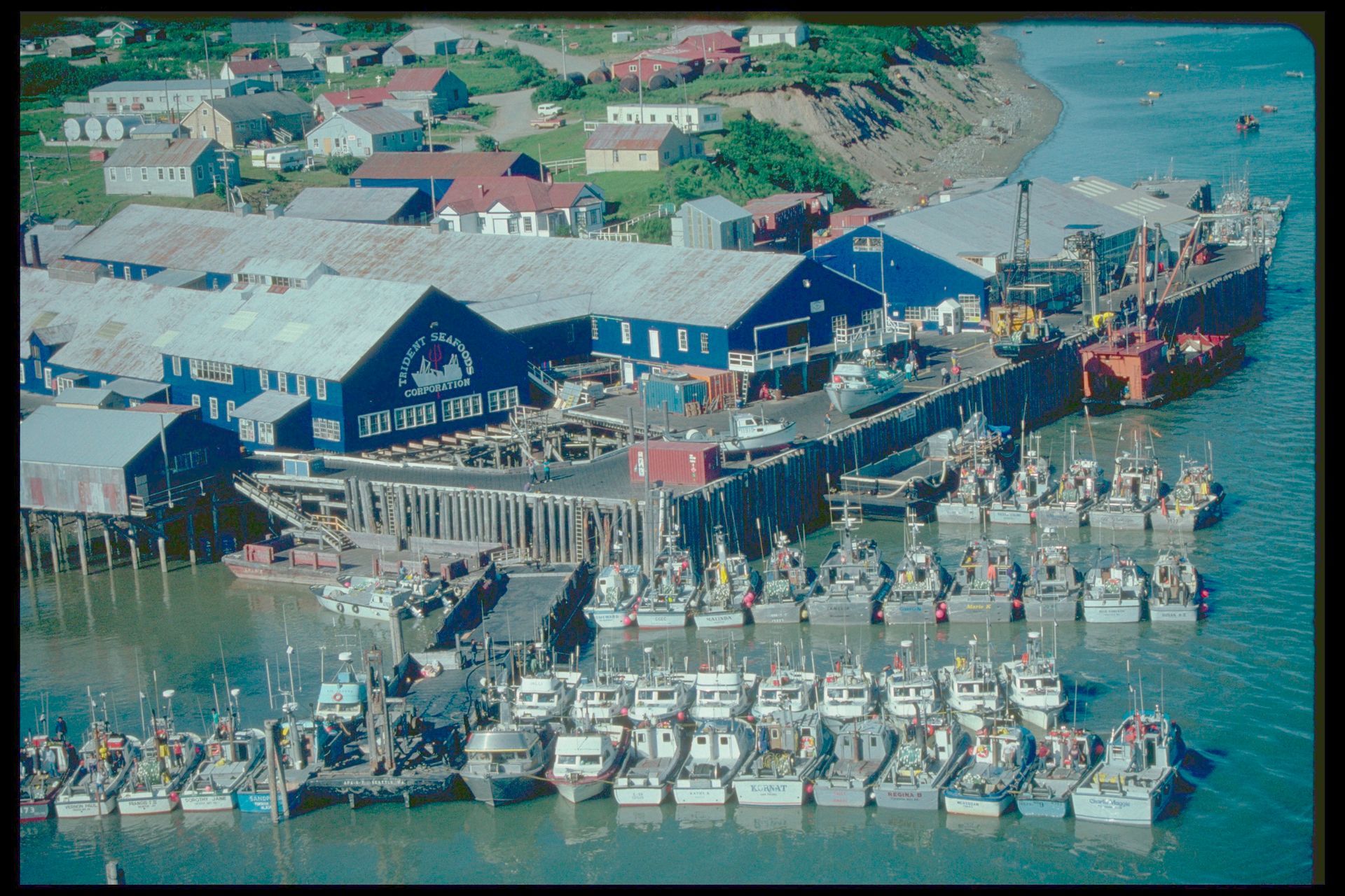 An aerial view of a harbor with many boats docked