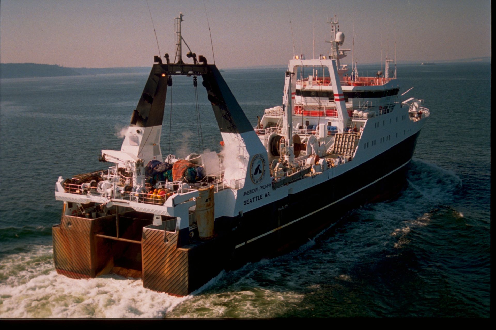 A large ship is floating on top of a body of water.