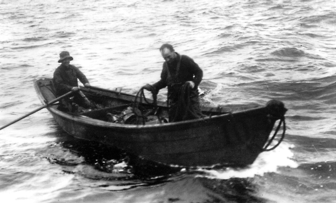Two men are rowing a boat in the ocean.