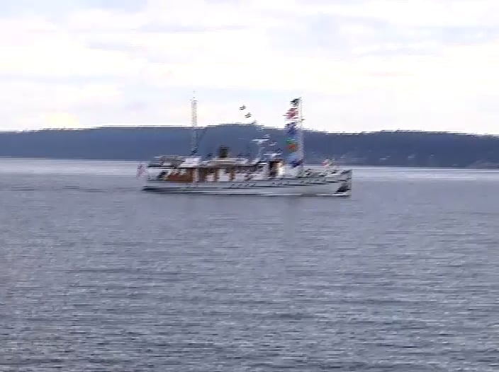 A boat is floating on top of a large body of water.
