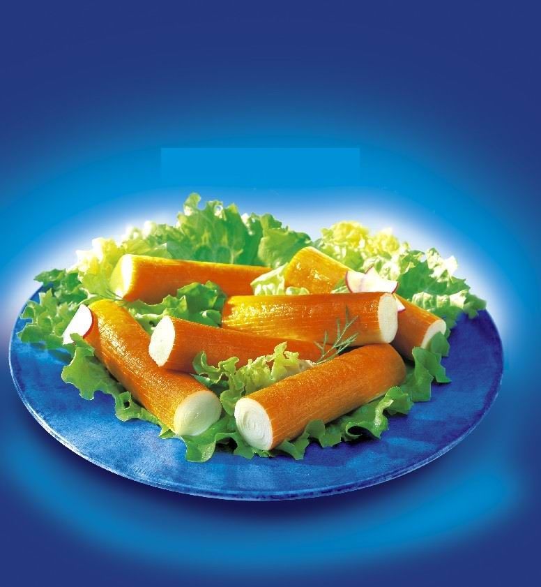 A blue plate topped with carrots and lettuce on a blue background