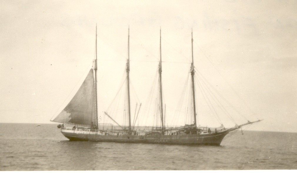 A large sailboat is floating on top of a large body of water.