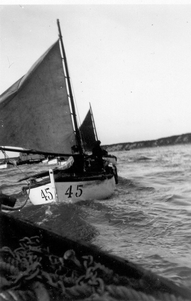 A black and white photo of a boat with the number 45 on it