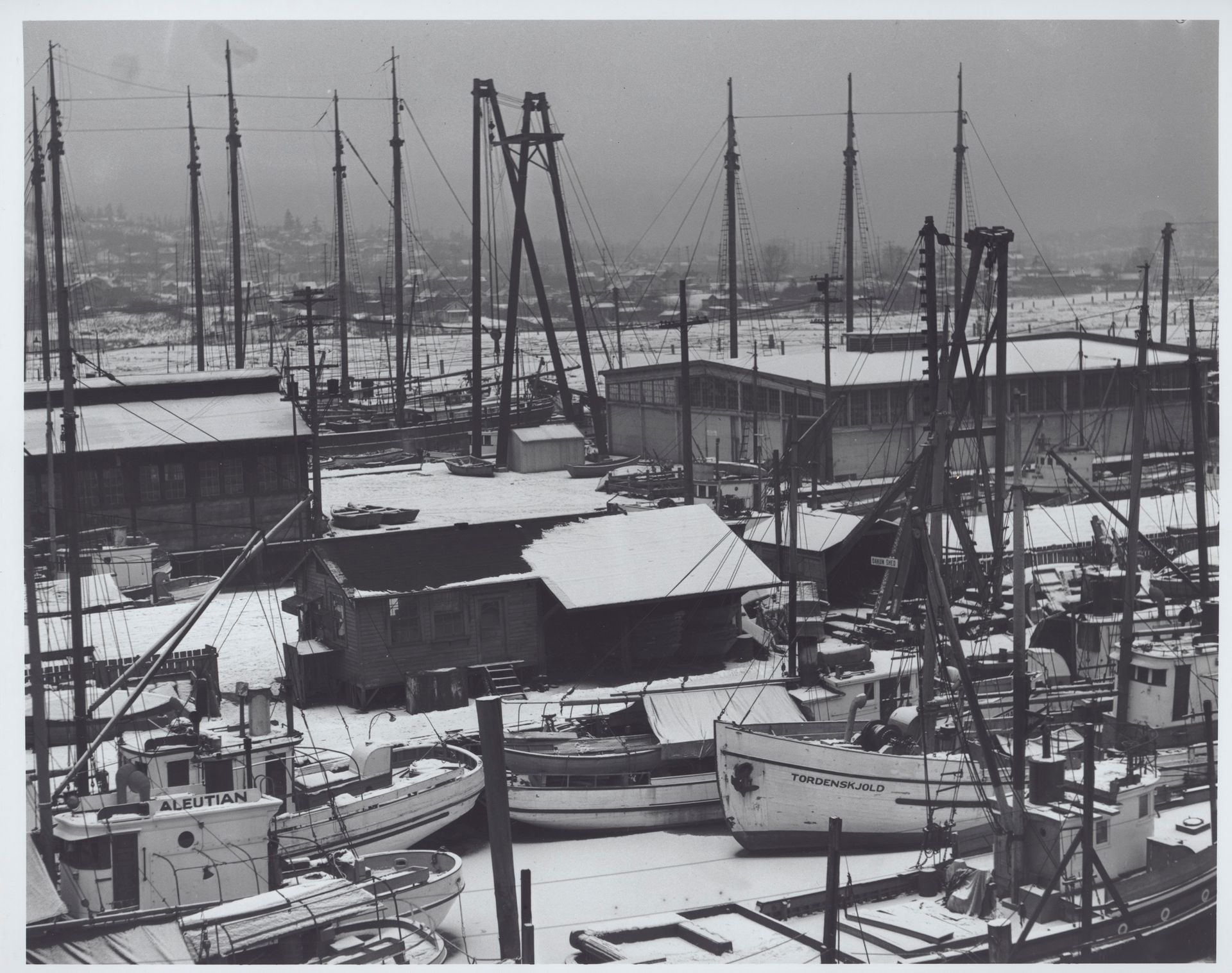 A black and white photo of boats in a harbor