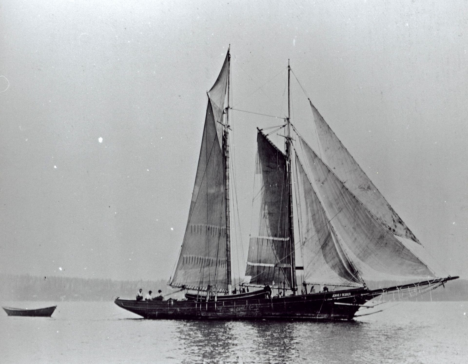 A black and white photo of a sailboat in the water
