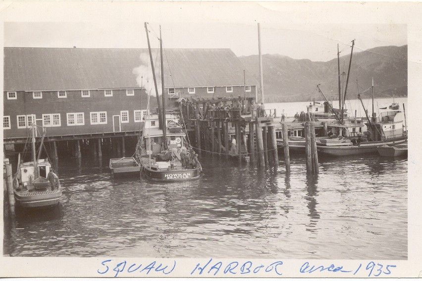 A black and white photo of boats in a harbor dated 1935