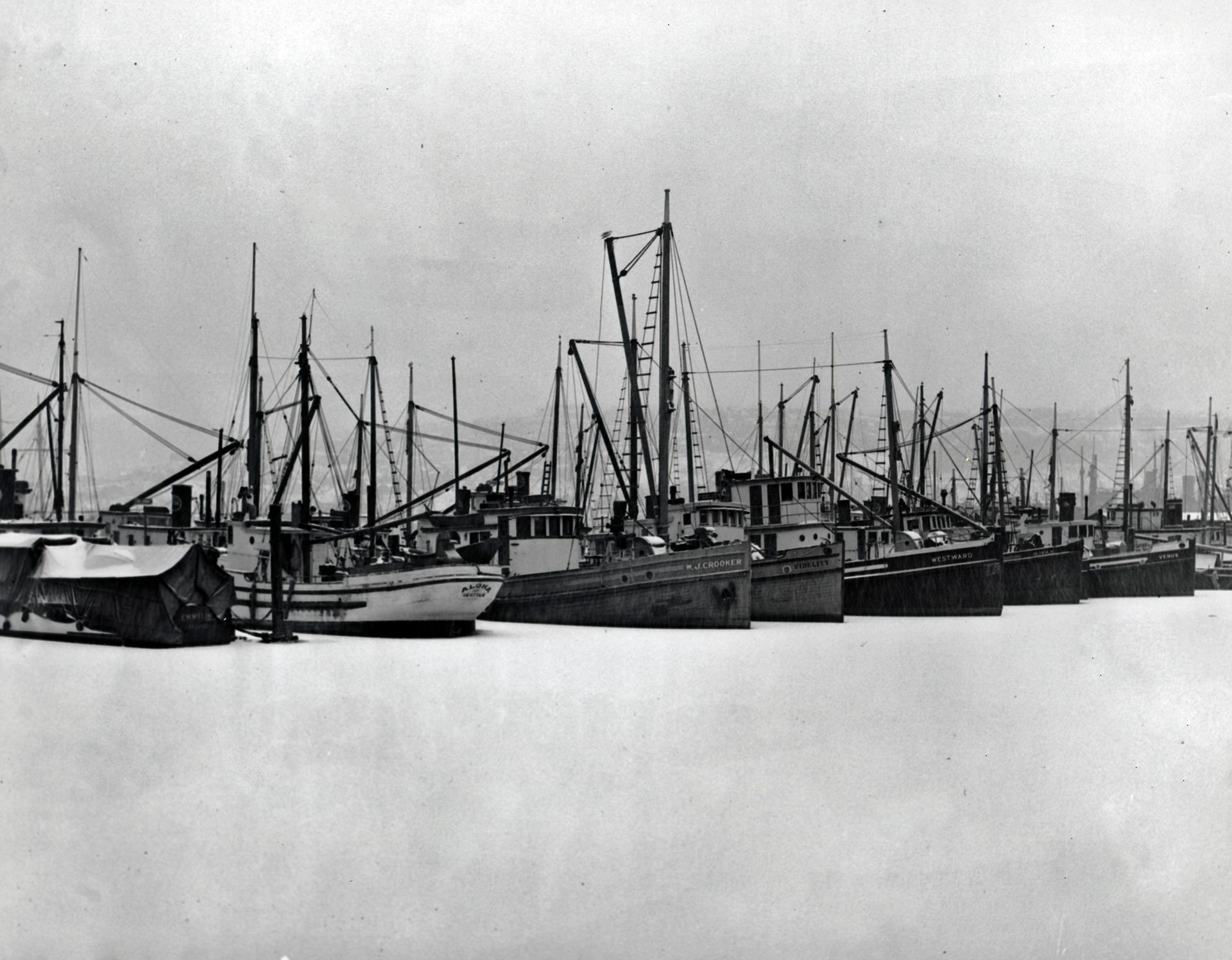 A black and white photo of boats in a harbor