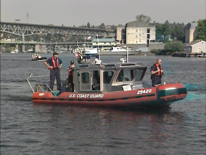 A us coast guard boat is floating on the water