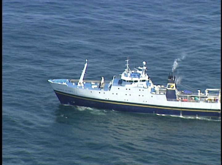 A large ship is floating on top of a body of water