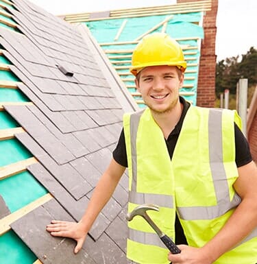 Roofing Repairs — Construction Worker Laying Roof Tiles in South Park, PA