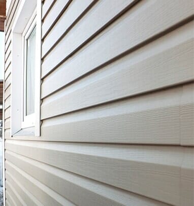 Window Replacements — Close up of Wall Finished in Vinyl Siding in South Park, PA