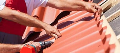 Roofing Company — Workers on Roof Installing Metal Tile in South Park, PA