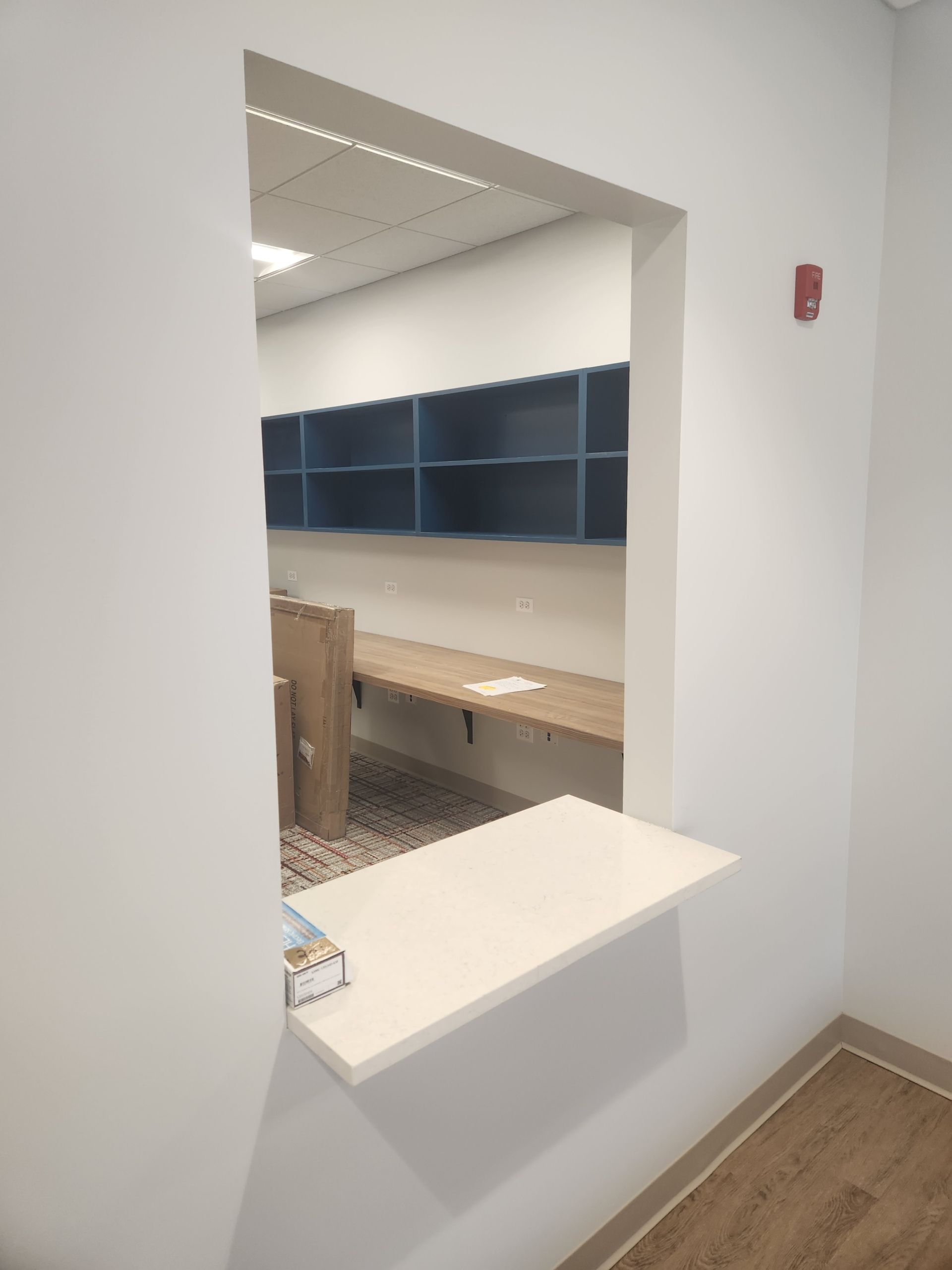 A room with a window and a desk in it