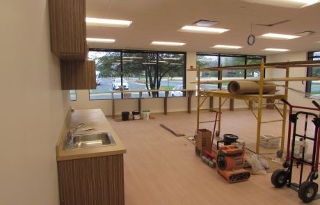 An empty room with a scaffolding and a hand truck