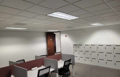 A room with cubicles and lockers in it
