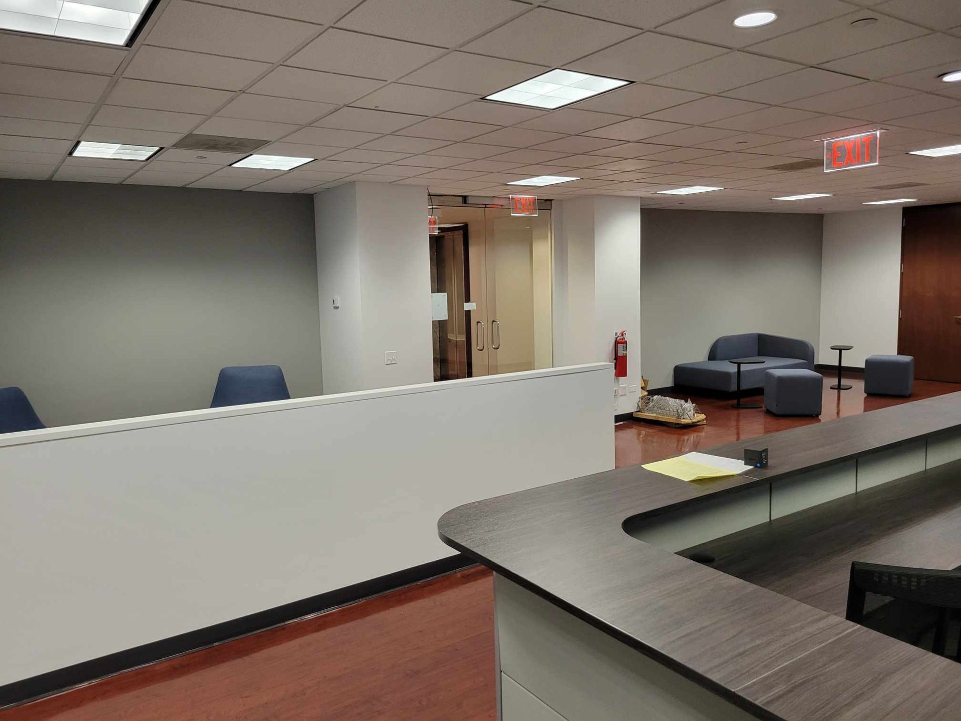 A reception area with a couch and a fire extinguisher