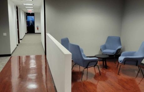 A hallway with chairs and a table in it