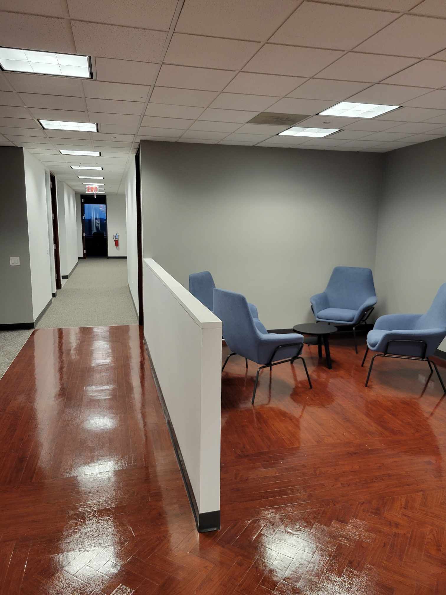 A hallway with chairs and a table in it