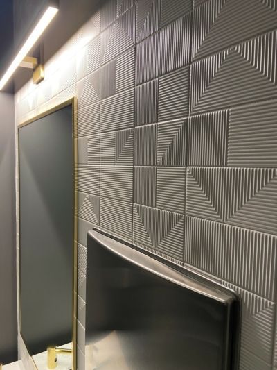 A television is sitting on a wall next to a mirror.